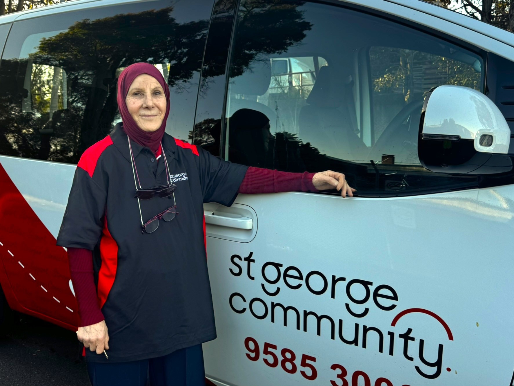Volunteer carer Suzie beside a St George Community Hyundai Staria